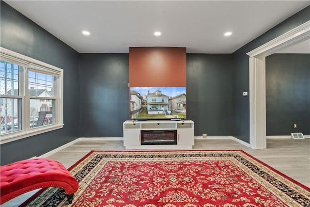 interior space with baseboards, visible vents, and wood finished floors