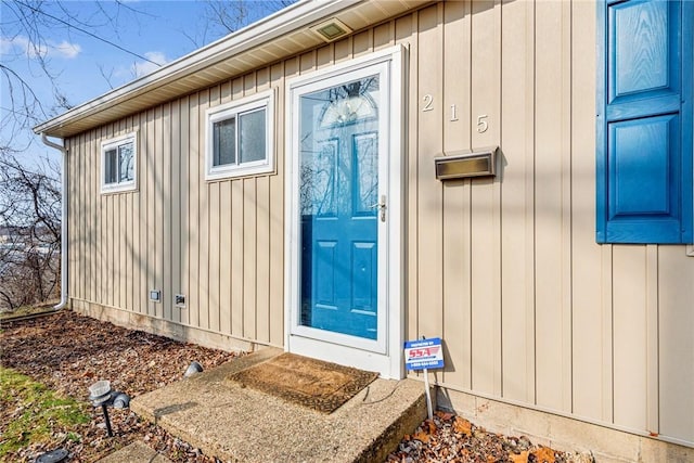 view of exterior entry with board and batten siding