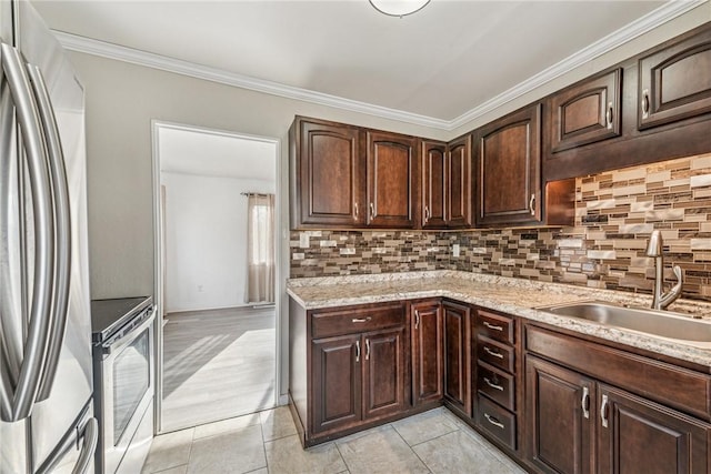 kitchen featuring stainless steel appliances, tasteful backsplash, a sink, and light stone countertops