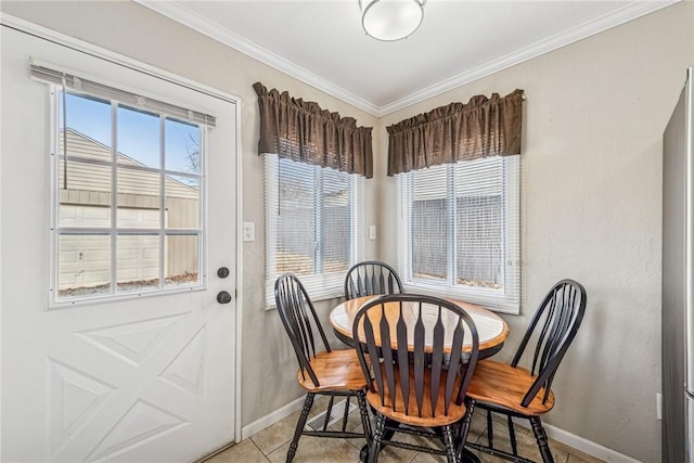 dining area featuring ornamental molding and baseboards