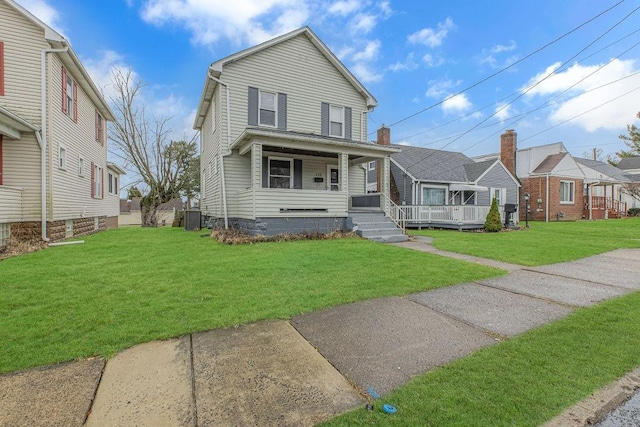 view of front facade featuring central AC unit, a front lawn, and a porch