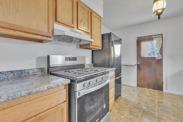 kitchen with baseboards, light countertops, appliances with stainless steel finishes, and under cabinet range hood