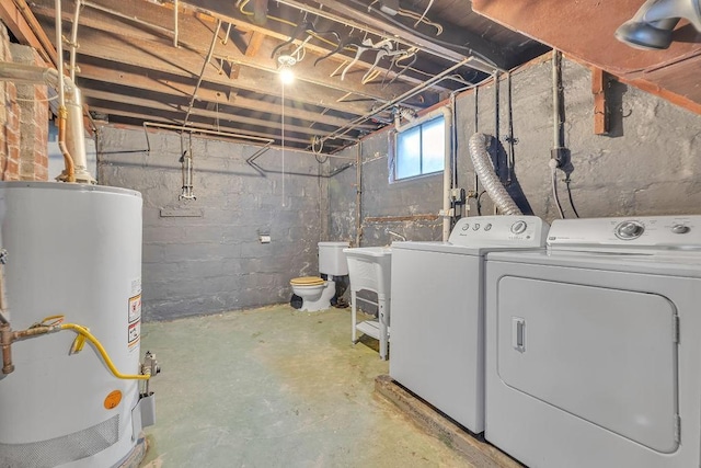 laundry area featuring laundry area, water heater, independent washer and dryer, and a sink