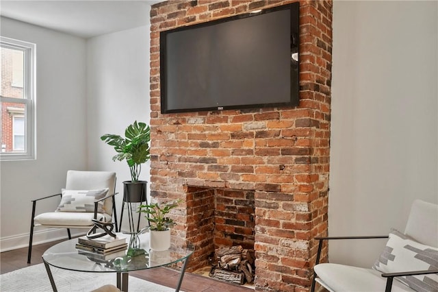 living area featuring baseboards and wood finished floors