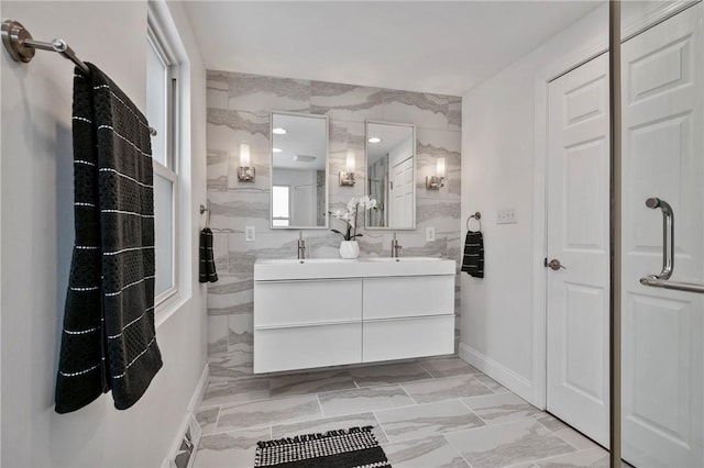 full bath featuring a shower, a sink, and double vanity