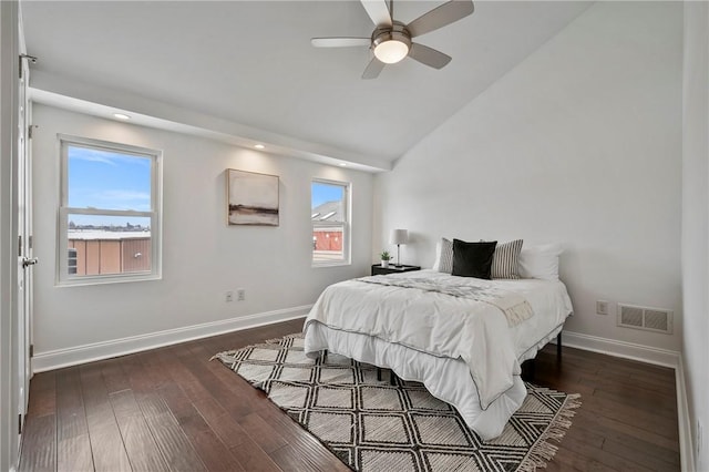 bedroom featuring lofted ceiling, dark wood finished floors, visible vents, and baseboards