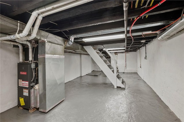 unfinished basement featuring heating unit and stairway