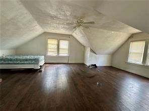 additional living space featuring a healthy amount of sunlight, vaulted ceiling, and wood finished floors