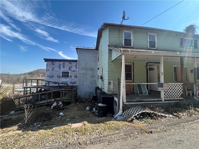 rear view of property featuring a porch