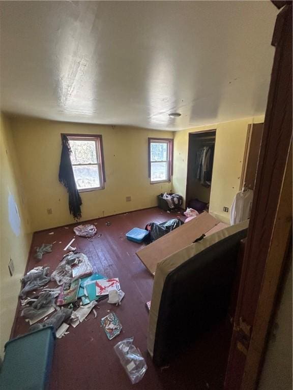 bedroom with multiple windows and wood finished floors