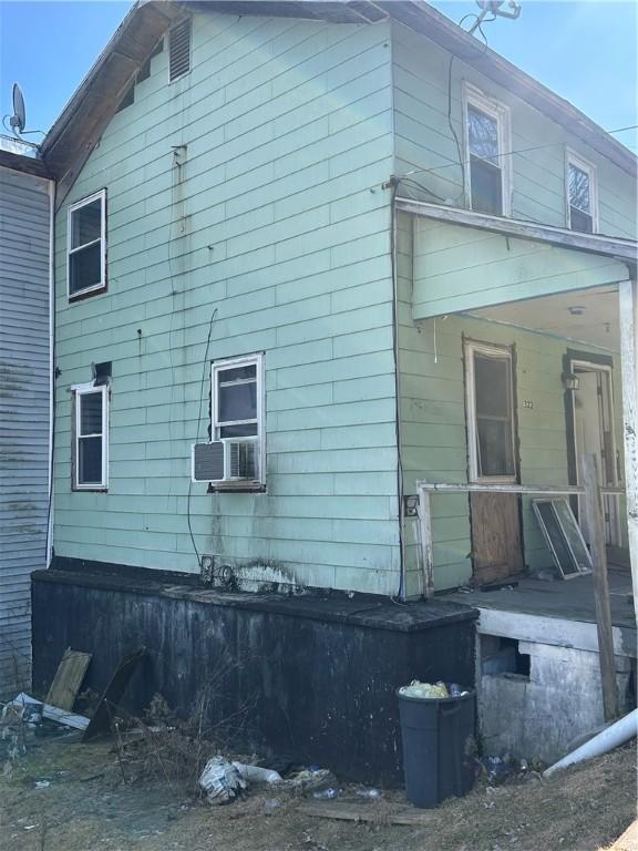 view of side of property with a porch