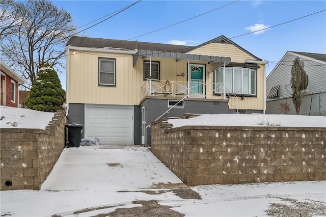 view of front of property featuring a garage and fence