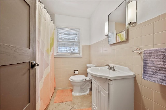 full bathroom with tile patterned flooring, tile walls, toilet, and vanity