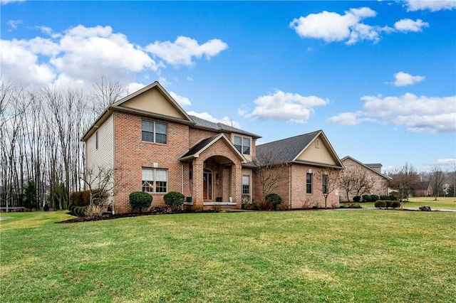 traditional-style home with brick siding and a front lawn