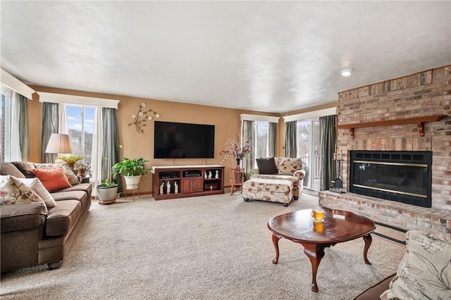 living area featuring carpet, a brick fireplace, and baseboards