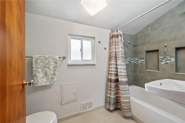 full bath featuring shower / tub combo, visible vents, toilet, and tile patterned floors