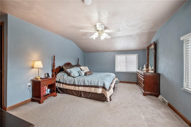 carpeted bedroom with lofted ceiling, visible vents, ceiling fan, and baseboards