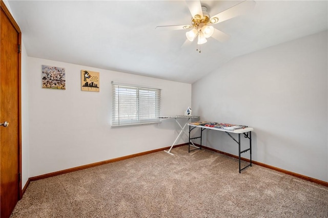 interior space featuring vaulted ceiling, a ceiling fan, and baseboards