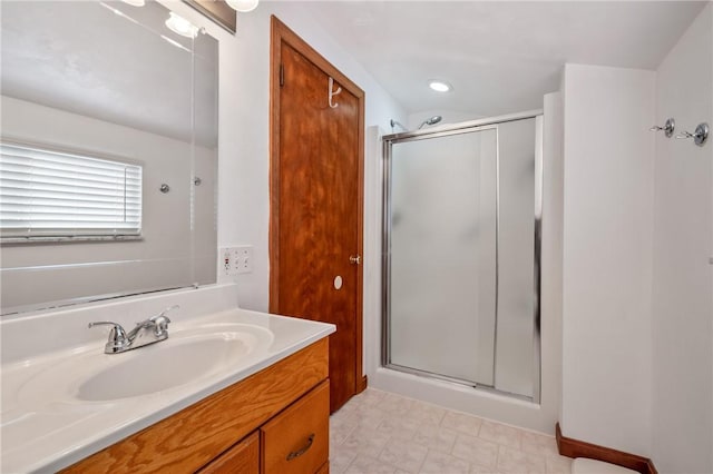 bathroom featuring a stall shower and vanity