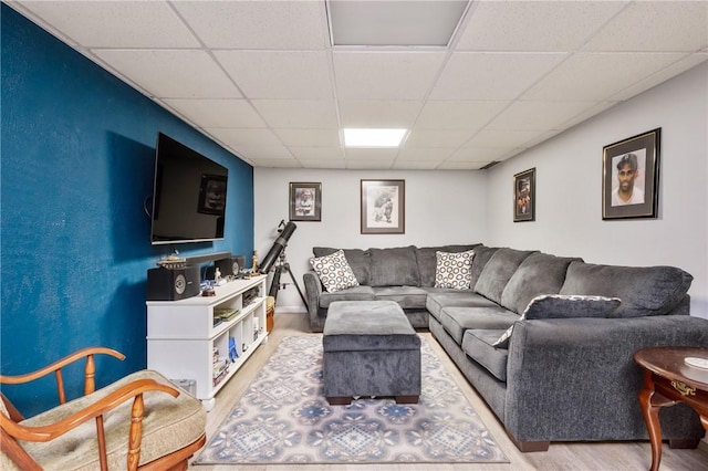 living room featuring a paneled ceiling and wood finished floors