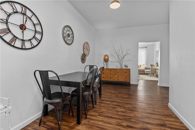 dining space with baseboards and wood finished floors