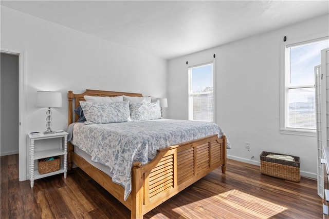 bedroom featuring wood finished floors and baseboards