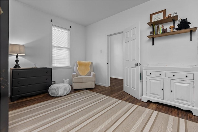 sitting room featuring baseboards and dark wood finished floors