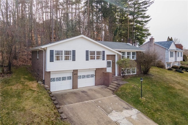 split foyer home featuring driveway, an attached garage, a front lawn, and brick siding