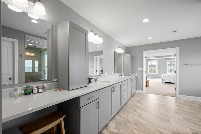 ensuite bathroom featuring ensuite bathroom, recessed lighting, vanity, baseboards, and a stall shower