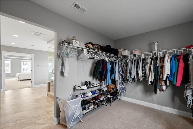 spacious closet featuring visible vents