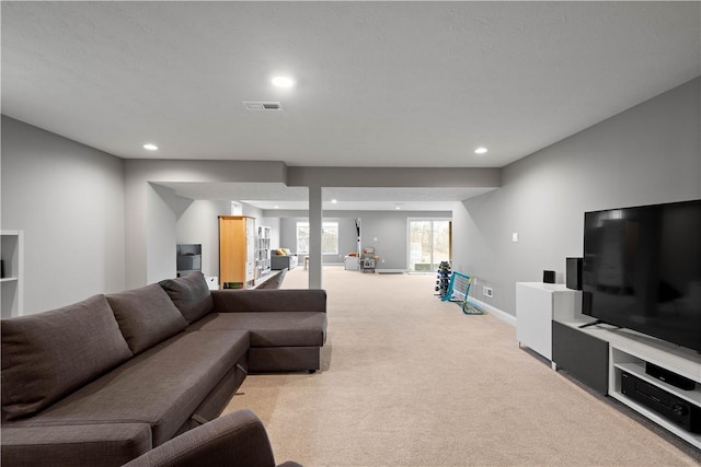 living room featuring recessed lighting, visible vents, baseboards, and light colored carpet