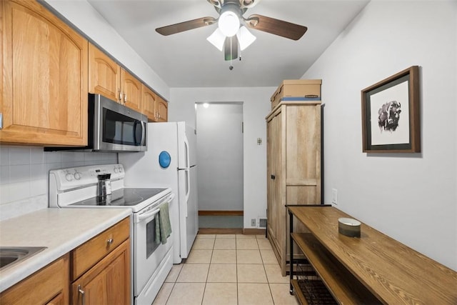 kitchen with light tile patterned floors, electric stove, light countertops, decorative backsplash, and stainless steel microwave