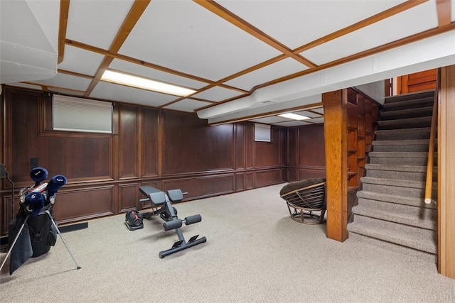 exercise room featuring carpet floors and wood walls