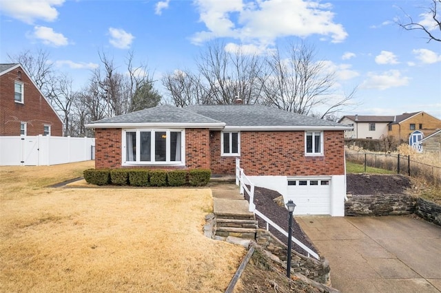 ranch-style home with brick siding, a front yard, fence, a garage, and driveway