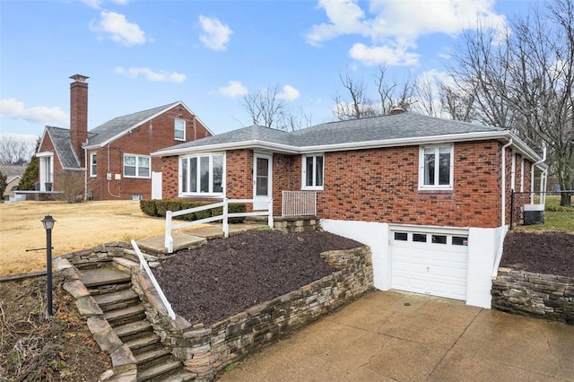 ranch-style house with a garage, brick siding, driveway, and a shingled roof