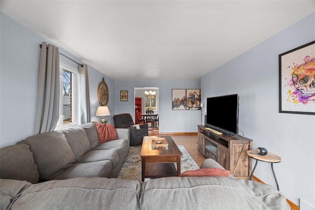 living area featuring an inviting chandelier and wood finished floors