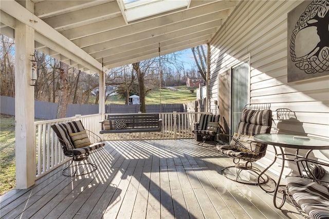 wooden terrace featuring fence