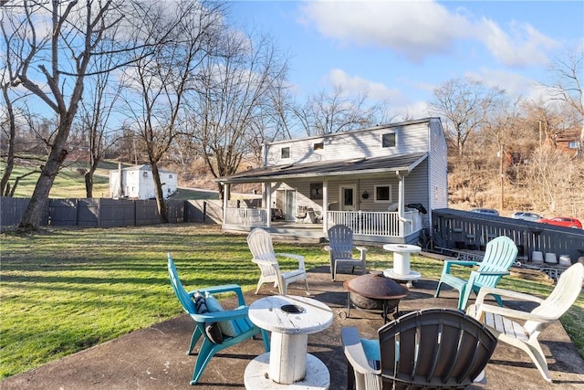 back of property with a patio, fence, a fire pit, and a lawn