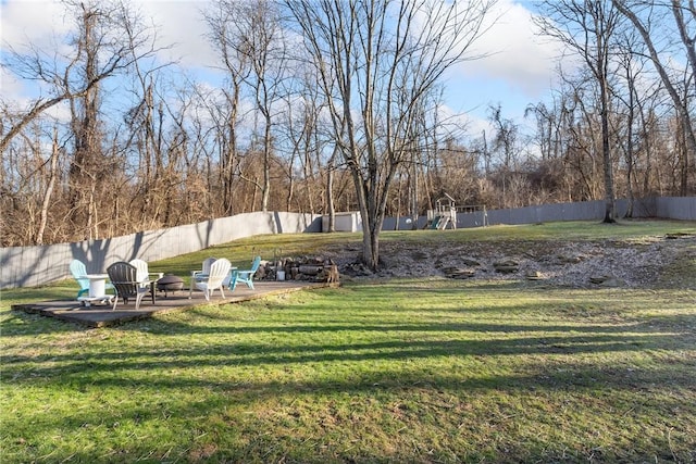 view of yard with a playground and a fenced backyard