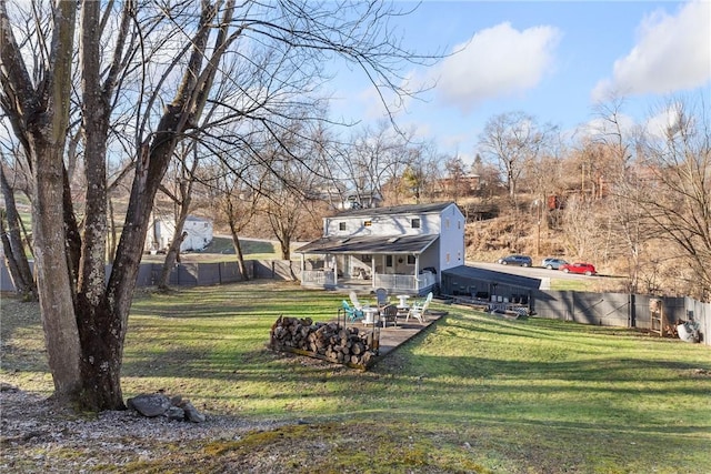 back of property with fence and a yard