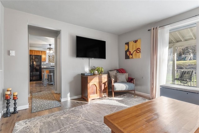 living area featuring light wood-type flooring and baseboards