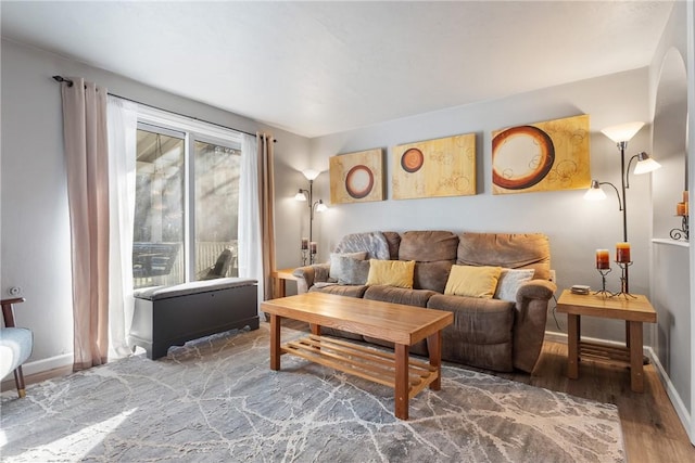 living room featuring baseboards and wood finished floors