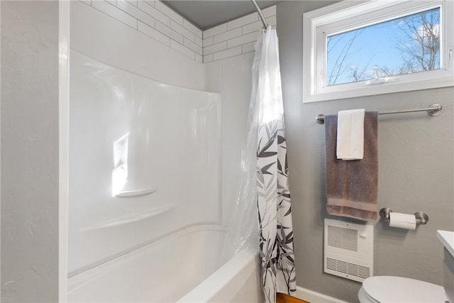 full bathroom featuring vanity, shower / bath combination with curtain, toilet, and heating unit