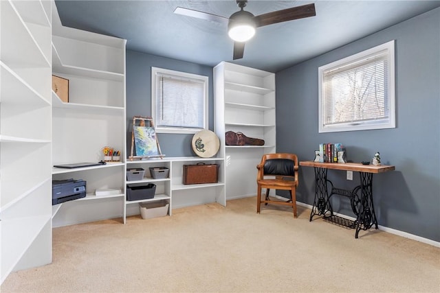 sitting room with a wealth of natural light, carpet, baseboards, and a ceiling fan