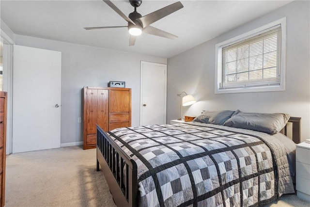 bedroom featuring light carpet, ceiling fan, and baseboards