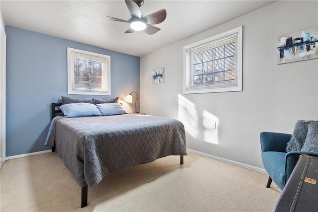 carpeted bedroom featuring ceiling fan and baseboards