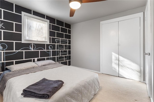 carpeted bedroom featuring ceiling fan and a closet