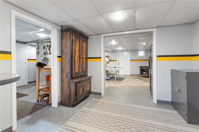 hallway with recessed lighting, a drop ceiling, and baseboards