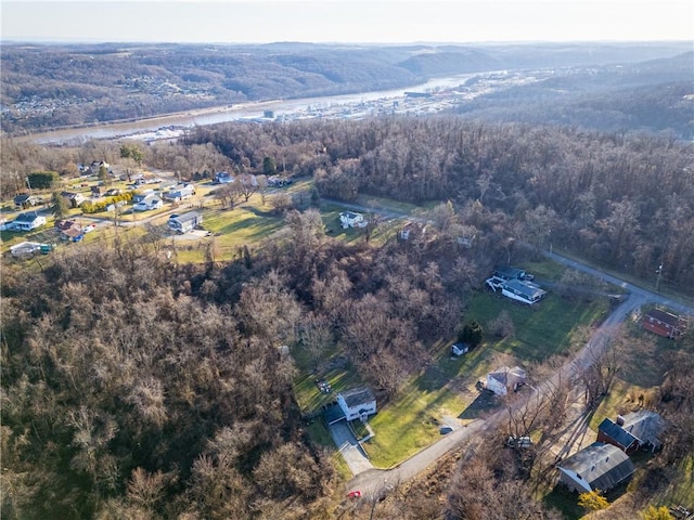 bird's eye view with a wooded view