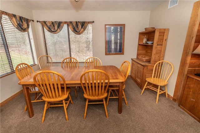 dining area featuring carpet, visible vents, and baseboards